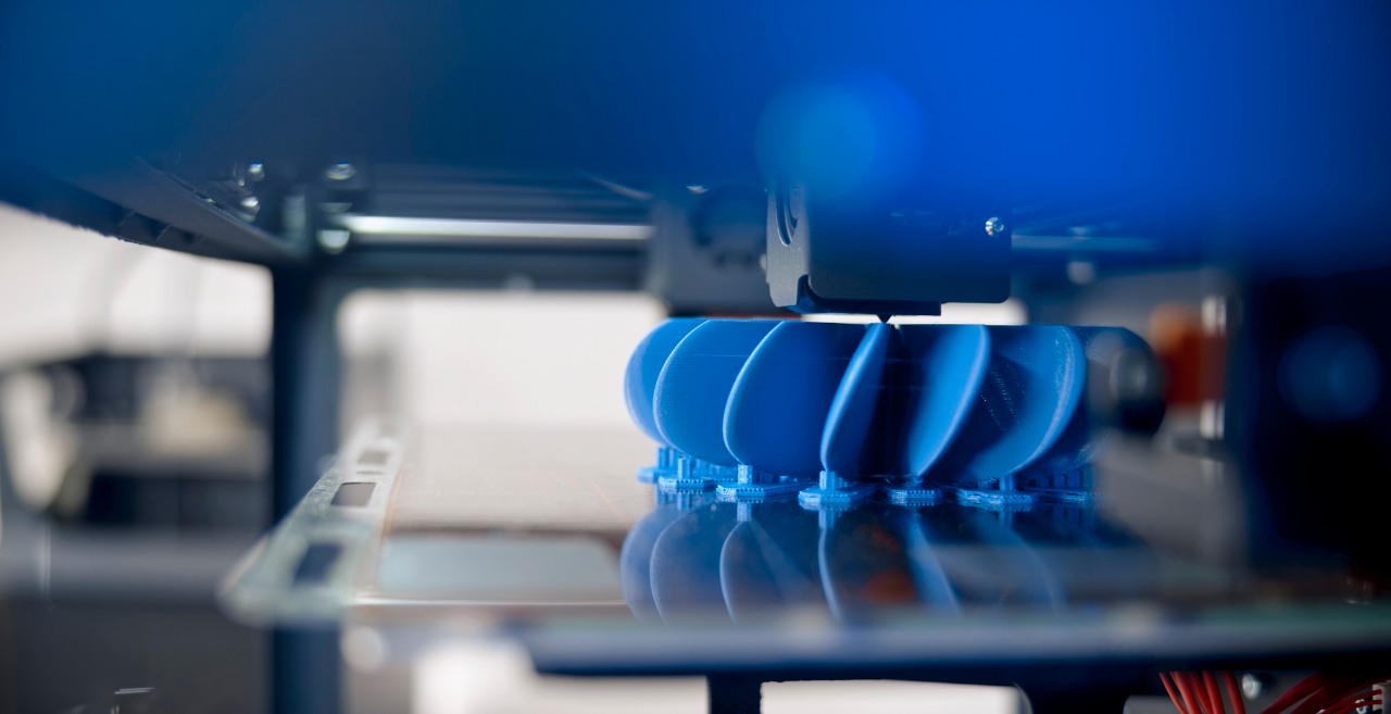 Close-up of plastic fan propeller model in 3D printing process.