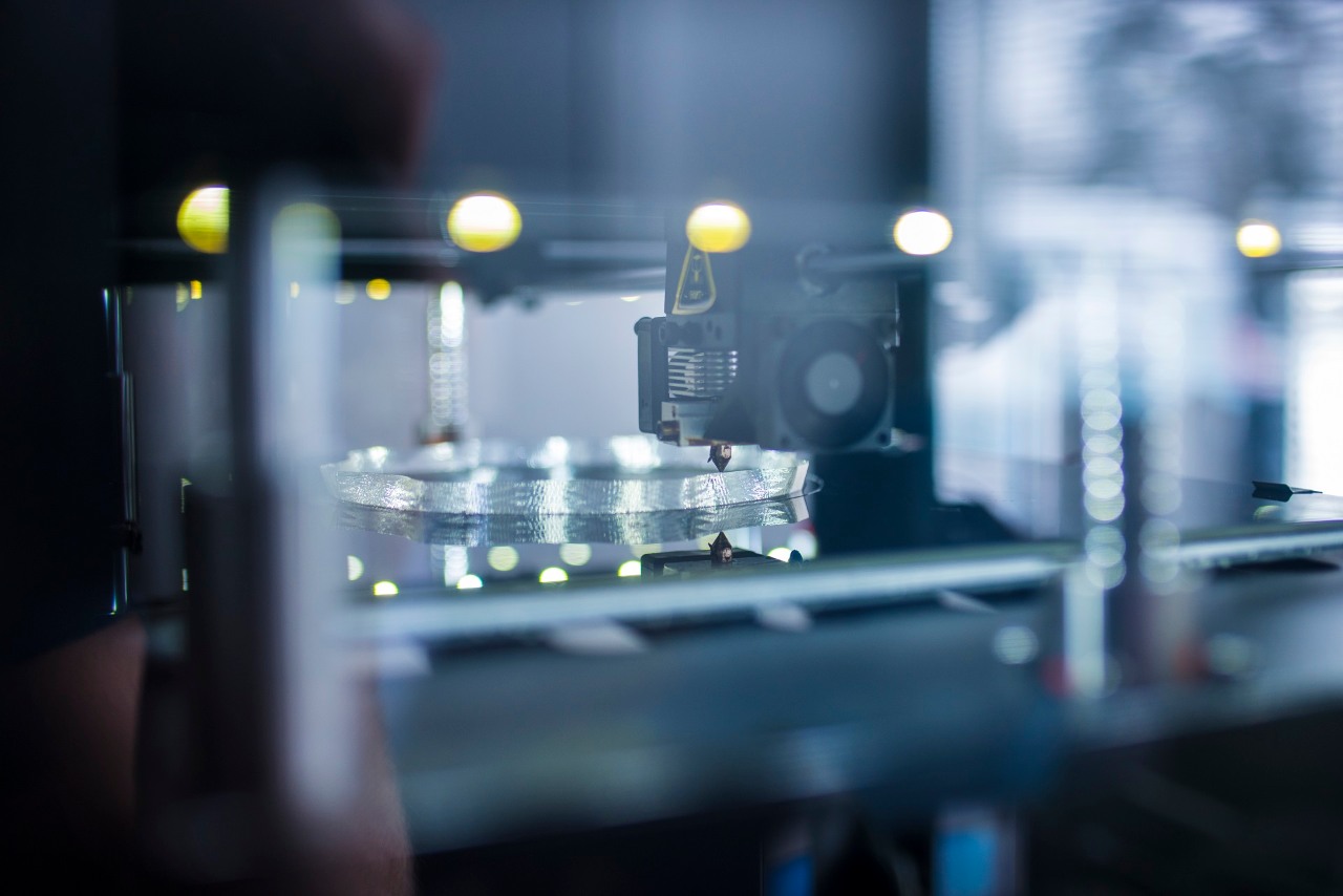 Close up shot of 3D printer printing 3D objects.